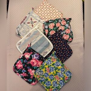 Vintage lot of 7 potholders marked USAir. All different patterns. Approx 7” sq.